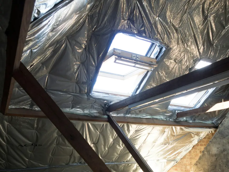Attic with insulated roof panels and skylights