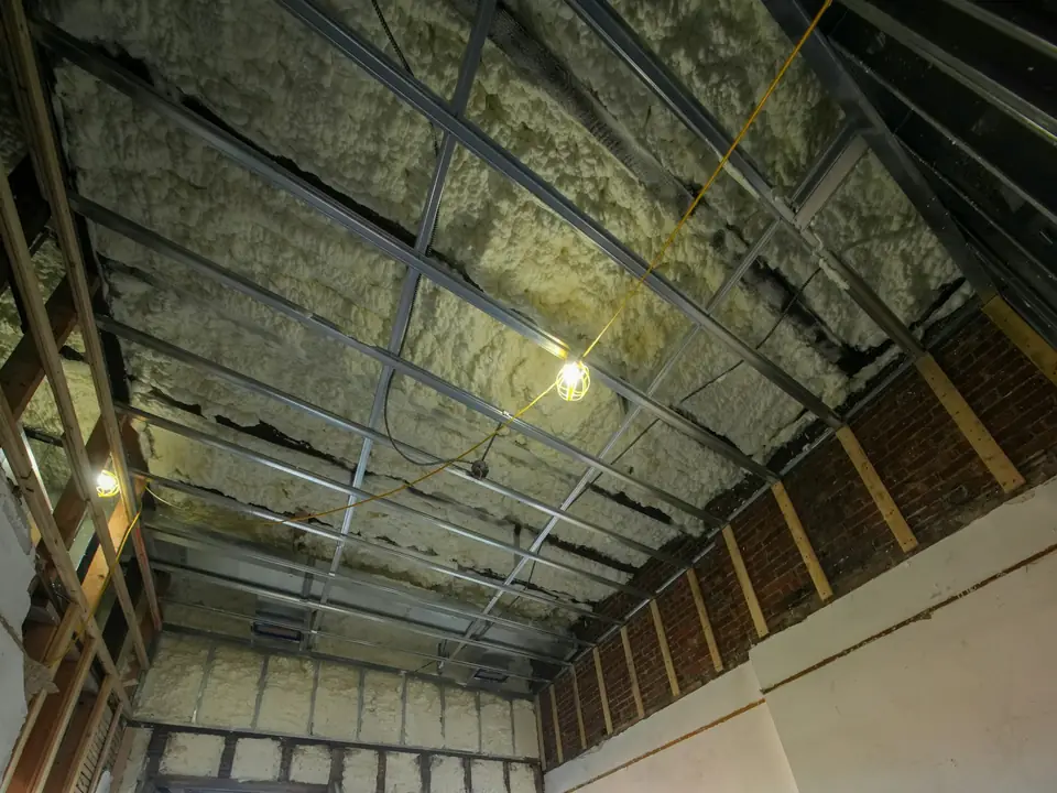 Attic room under construction with exposed framing and insulation